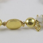 A close up of the gold bead and flower