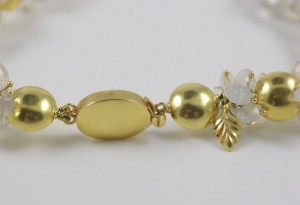 A close up of the gold bead and flower