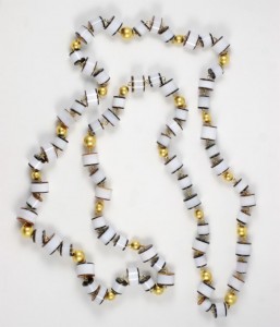 A long necklace of white and gold beads.