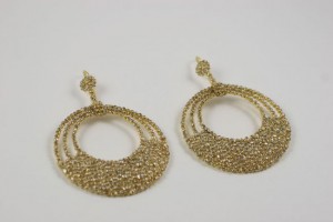 A pair of gold earrings with three circles.