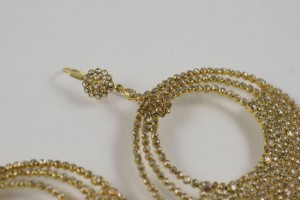 A close up of the gold chain on a white background