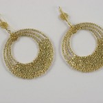 A pair of gold earrings with chains and circles.