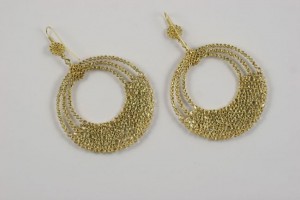 A pair of gold earrings with chains and circles.