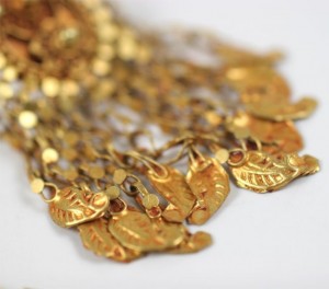 A close up of gold jewelry on display.