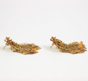 A pair of gold earrings with a bird on them.