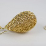 A pair of gold earrings with white stones.