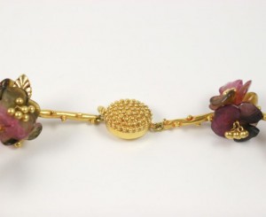 A close up of the gold chain with flowers