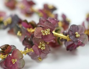 A close up of some purple flowers with gold stems