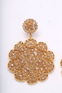 A pair of gold and diamond earrings.