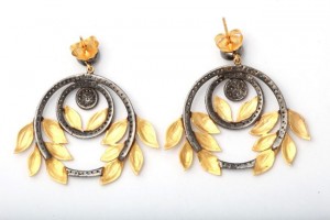 A pair of earrings with yellow stones and black diamonds.