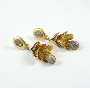 A pair of gold and diamond earrings.