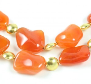 A close up of an orange necklace