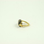 A gold ring with black stones on it