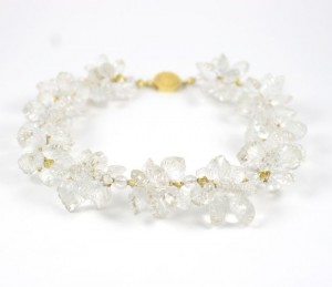 A bracelet with clear stones and gold clasp.