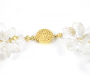 A close up of the gold bead on the necklace