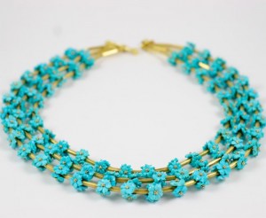 A necklace with turquoise flowers and gold chain.