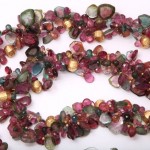 A long necklace of multicolored stones is shown.