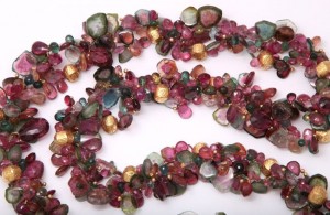 A long necklace of multicolored stones is shown.