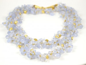 A necklace of blue chalcedony and gold beads.