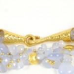 A close up of some gold jewelry with blue stones