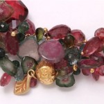 A close up of the necklace with many different colored stones