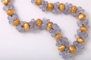 A close up of the necklace on a white background