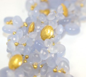A close up of some white and gold beads