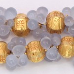 A close up of some gold beads and blue buttons