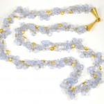 A long necklace with gold and blue beads