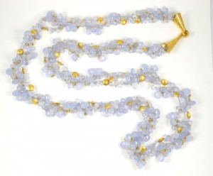 A long necklace with gold and blue beads
