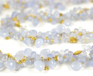 A close up of the necklace on a white surface