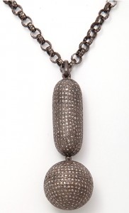 A long necklace with a large pendant and small chain.