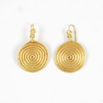 A pair of gold earrings with spiral design.