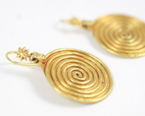 A pair of gold earrings with spirals and stars.