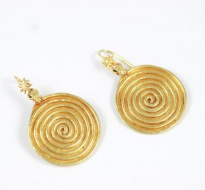 A pair of gold earrings with spirals on them.