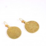 A pair of gold earrings with a round design.