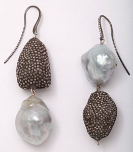 A pair of earrings with pearls and diamonds.