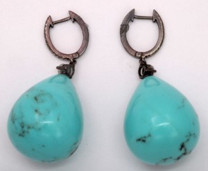 A pair of turquoise earrings with black patina.