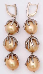 A pair of gold and diamond earrings with pearls.
