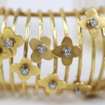 A close up of the gold bracelet with flowers