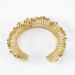 A gold bracelet with a bunch of small pieces