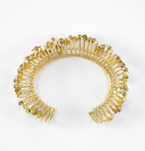 A gold bracelet with a bunch of small pieces