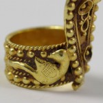 A gold ring with a bird on it