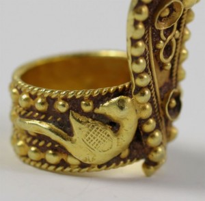 A gold ring with a bird on it
