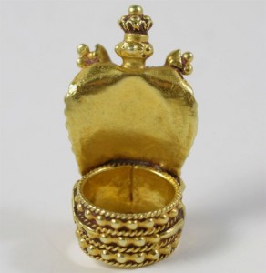 A gold crown shaped trinket box with a lid.