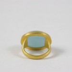 A gold ring with a blue stone on top of it.