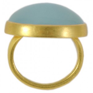 A gold ring with a light blue stone on top of it.