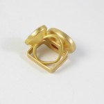 A gold ring with three circles on it.