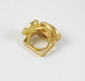 A gold ring with three circles on it.