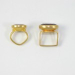 Two gold rings are shown with one of them being a square.